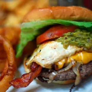 The most delicious $5 build-your-own-burger ever! This one includes beef, cheddar, fried egg, bacon, grilled onions, and guac