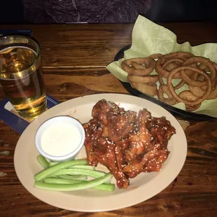 Buffalo wings and onion rings with a $3 PBR