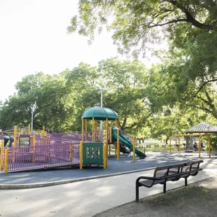 The large, mature trees cover most of the playground with ample shade.