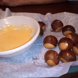 a bowl of dipping sauce and pretzels
