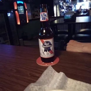 a plate of food and a bottle of beer