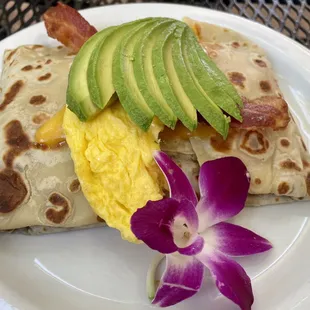 Breakfast crepe with avocado slices on top