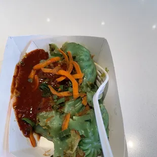 a salad in a paper container