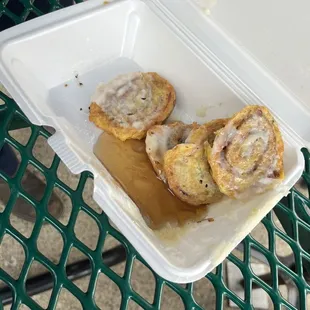 cinnamon rolls in a styrofoam container