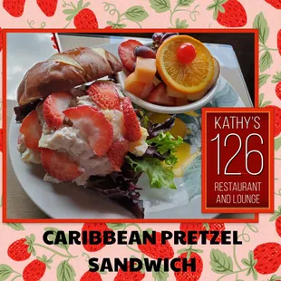 a plate with a sandwich and fruit salad