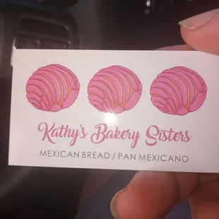 a hand holding a business card