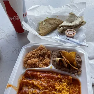 Red cheese enchiladas, rice, beans and taco.