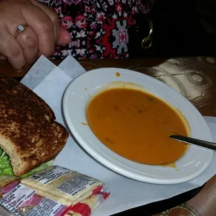 Cup of tomato basil soup and half chicken salad sandwich