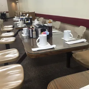 a long table with cups of coffee on it