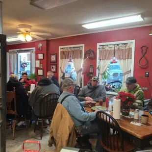 people sitting at tables in a restaurant