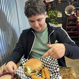 Chicken sandwich with mozzarella sticks.