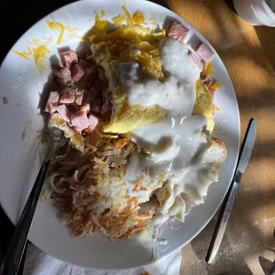 Ham and cheese omelet hash browns and toast and gravy. Yum