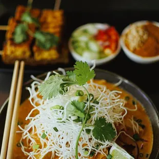 a bowl of food with chopsticks