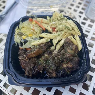Jerk wings with Rasta pasta and cabbage