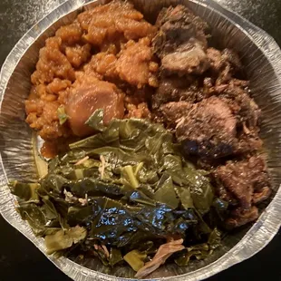 Jerk Pork meal with candied yams and collard greens