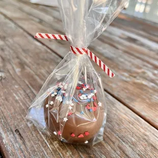 a chocolate apple wrapped in a cello bag