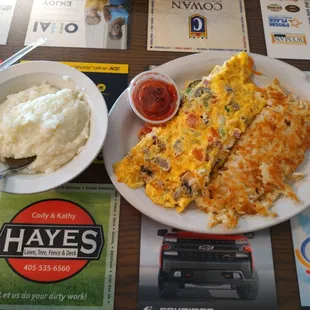 Three-egg everything omelet with hash browns and grits (sub for biscuits and gravy)
