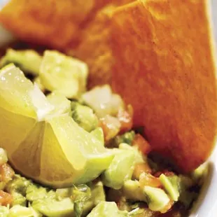 a bowl of guacamole and chips