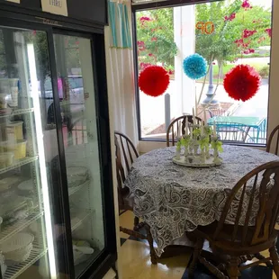 a table and chairs in front of a refrigerator