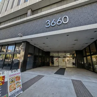 Located at the back of the building. Go through these doors, down the hallway to the left.