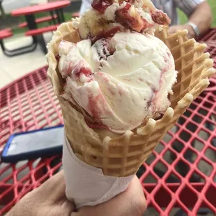 Waffle cone with strawberry cheesecake ice cream