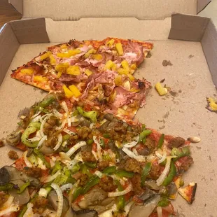 a half eaten pizza in a box