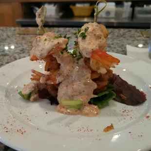 The Remy Stack: 3 slices of lightly breaded/fried green tomatoes, 4 smoky, spicy grilled shrimp, and a tasty remoulade sauce. Bangin&apos;.