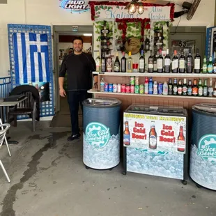 a man standing in front of a mini bar