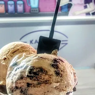 a hand holding a scoop of ice cream