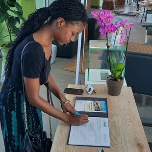 Katrina  intern  signing  the Katrina Museum  quest  book