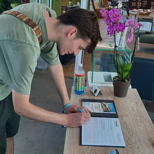 Visitor signs  thr Katrina Museum quest  book