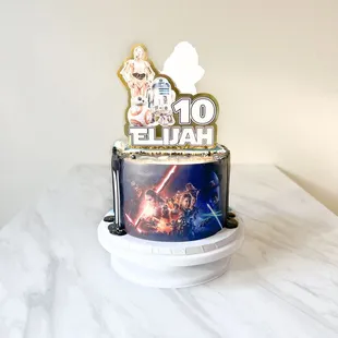 Double theme half &amp; half designed cake. One side Star Wars and the other side Moana to celebrate 2 celebrants in one.