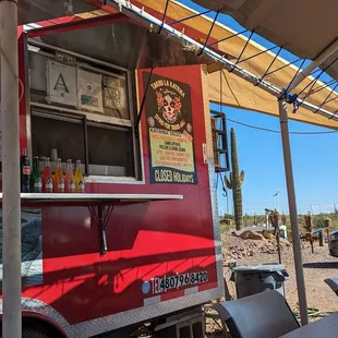 a taco truck with tables and chairs