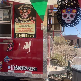 a red food truck with a sign that says closed holidays