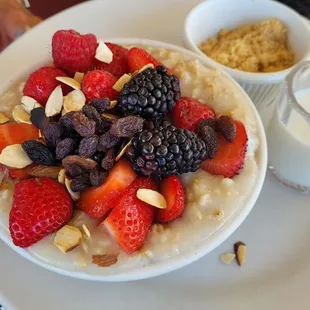 Oatmeal with fresh fruit, brown sugar &amp; cream.