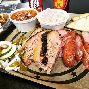 a platter of meat and sides