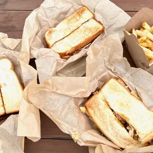 three sandwiches and french fries