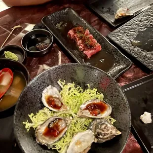 a plate of raw oysters on a table
