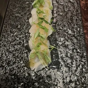 scallops on a black plate