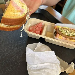 a person holding a sandwich