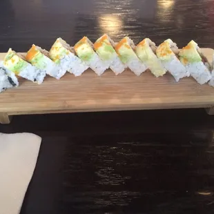 Benetton roll. Salmon, eel, cucumber, topped with avocado and masago.