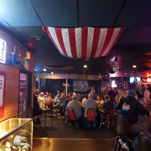 people sitting at tables in a restaurant