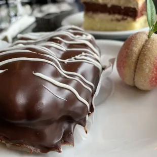 Close up of an eclair and peach cookie