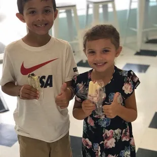 two young children eating ice cream