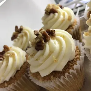 cupcakes with white frosting and pecans