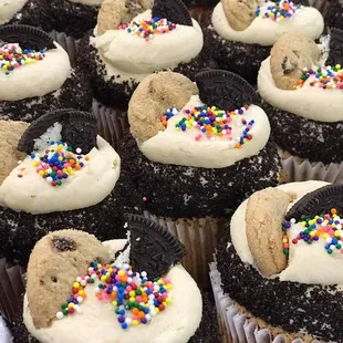 a tray of cookies and cupcakes