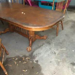 Two tables are available next to food truck in a covered area.