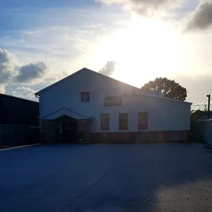 an empty parking lot with a building in the background
