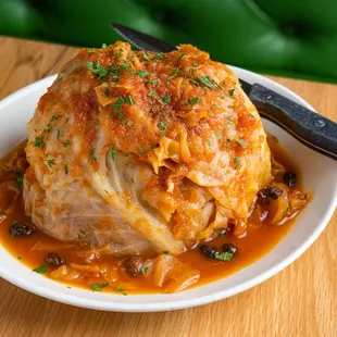 a white plate with a stuffed cabbage