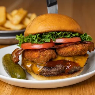 a burger and pickle on a plate